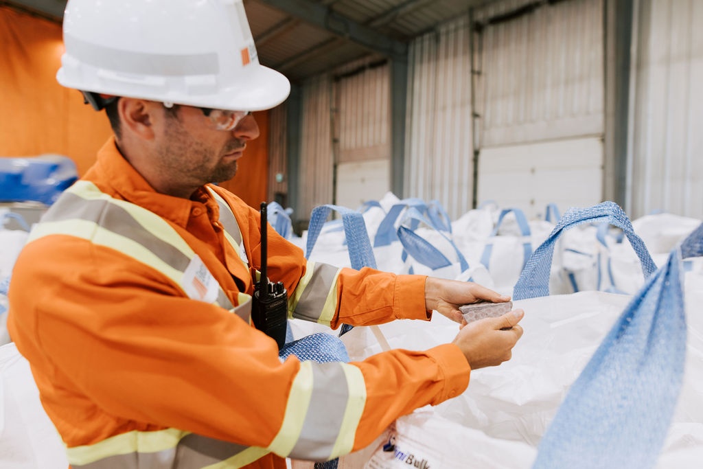 Electra employee inspecting nickel-cobalt recycled from lithium-ion batteries.